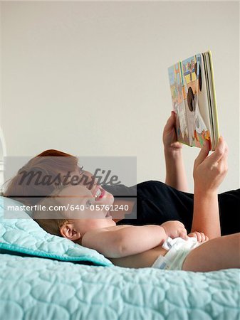 USA, Utah, Orem, Mother reading book with baby (6-11 months)