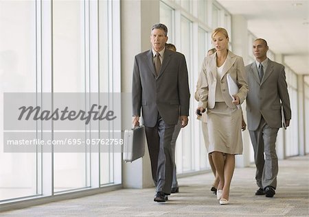 Executives walking through corridor of office building