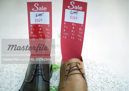 Shoes holding tag with sale price and sizes