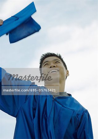 Male graduate taking off cap