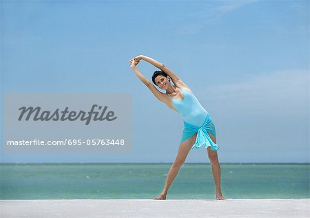 Woman stretching on beach