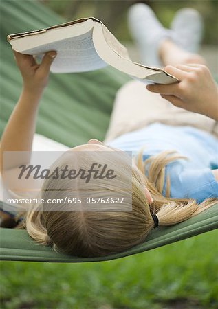 Girl reading book on hammock
