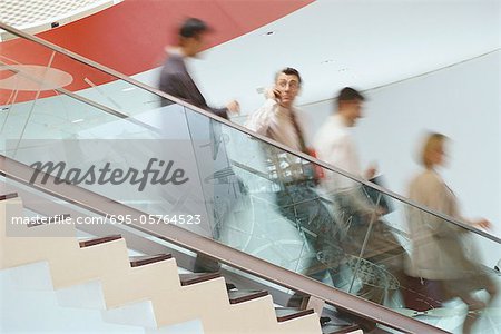 Business executives going down staircase