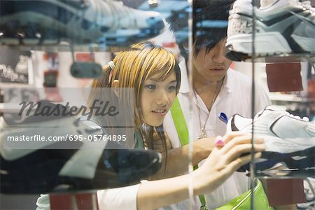 Young couple looking at sports shoes in store