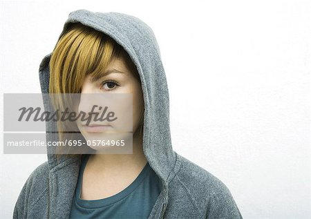 Young woman wearing hood, looking at camera, portrait