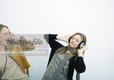 Teenage girls listening to headphones