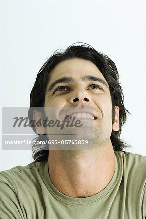 Man, looking up, smiling, portrait