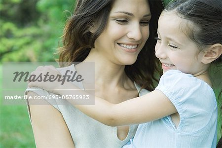 Girl and mother smiling, portrait