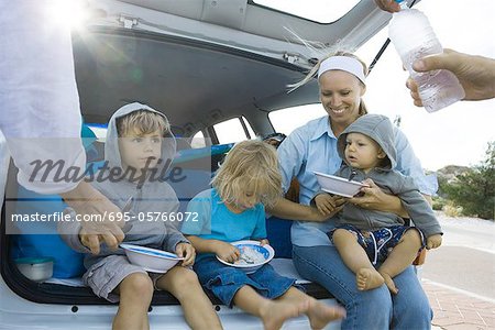 Children eating meal in back of car