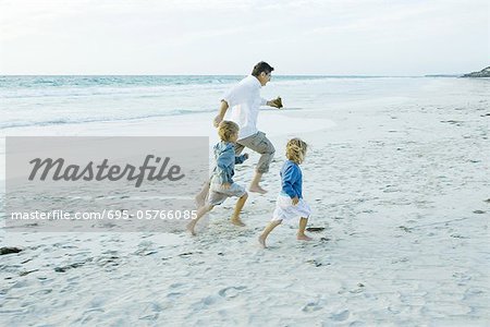 Family on beach, running