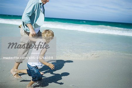 Man and boy walking on beach
