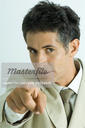 Businessman pointing at camera, portrait