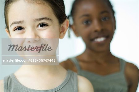 Girl smiling at camera, friend in background