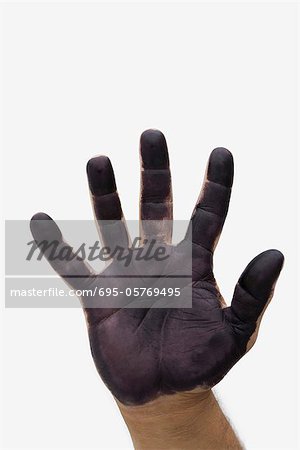 Man's hand with black paint on palm