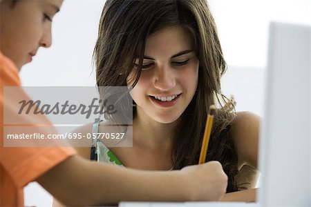 Tutor helping elementary school student with homework