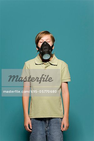 Boy wearing gas mask, eyes closed