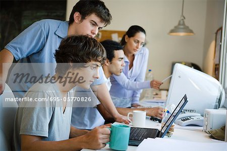 College students collaborating together using computers