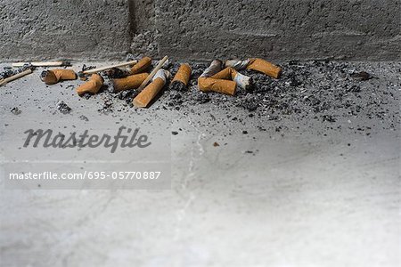 Discarded cigarette butts on ground