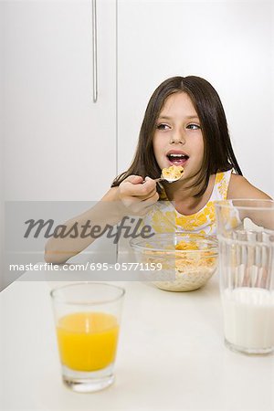 Girl eating cereal for breakfast