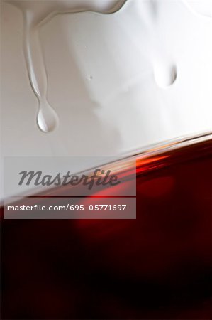 Tears of wine on glass of red wine, close-up