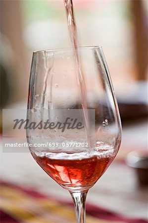 Pouring glass of rose wine