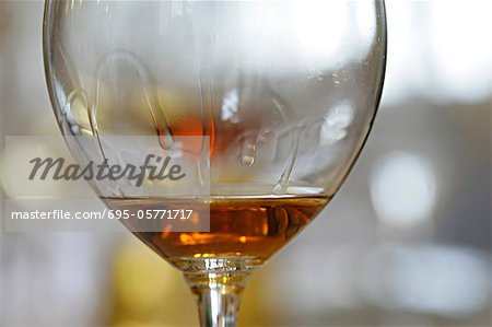 Tears of wine on glass of rose wine