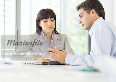 Man and woman having discussion in office