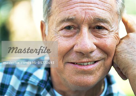 Mature man smiling at camera, close-up, portrait
