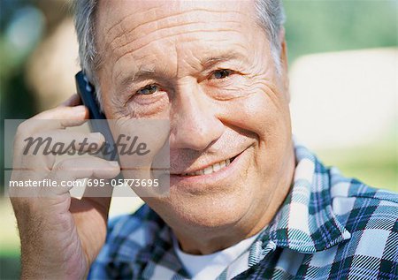 Mature man with a cell phone, close-up, portrait