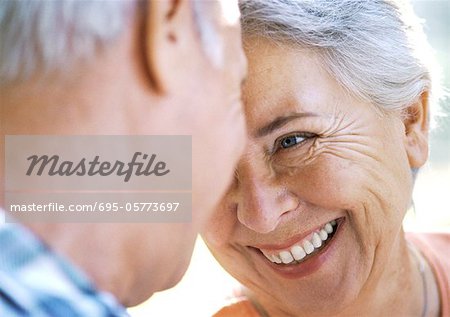 Mature man and woman smiling, close-up