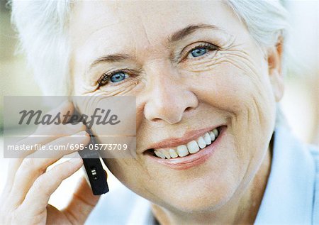 Mature woman with cell phone, close-up, portrait