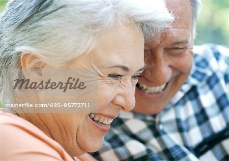 Mature man and woman smiling, close-up