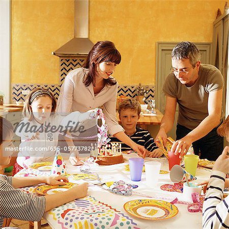 Family gathered around table for birthday party