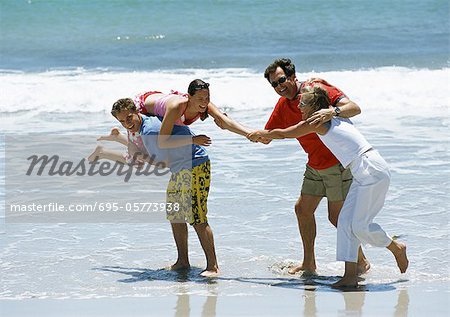 Family playing together at the beach.