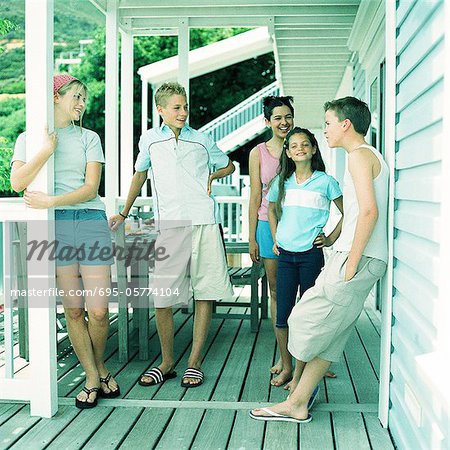 Young people standing on porch