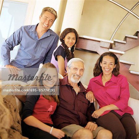 Grandfather, parents and daughters smiling