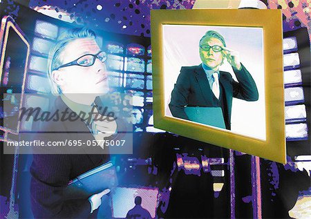 Young businessman standing in front of computer monitor, same man on screen, digital composite.