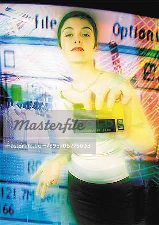 Young woman holding credit card toward camera, digital composite.