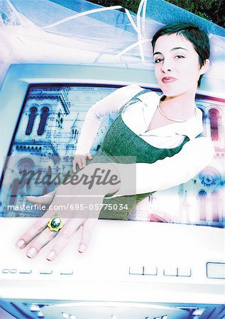 Young woman emerging from computer monitor, showing ring on finger, digital composite.