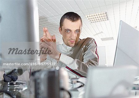 Man at desk looking into camera, portrait