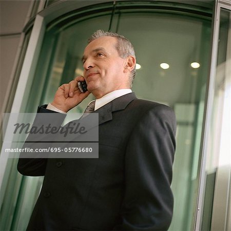 Businessman on cell phone, portrait