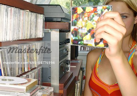 Young female holding up CD