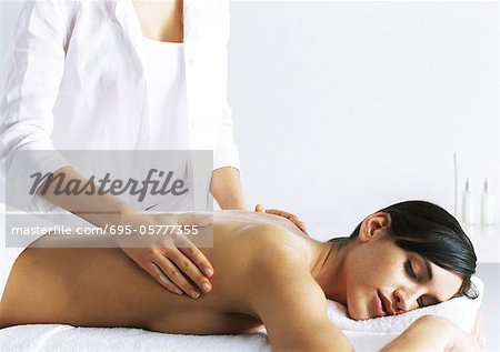 Woman massaging second woman on massage table