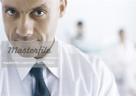 Businessman looking at camera with eyebrow raised