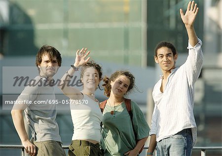 Group of young people waving