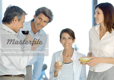 Mature group of friends having before dinner drinks