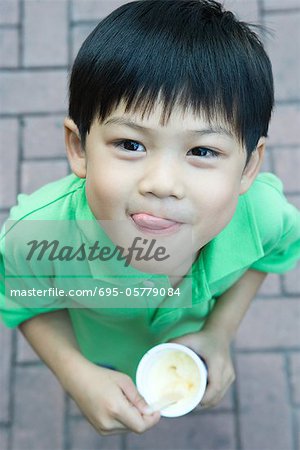 Boy eating ice cream, licking lips