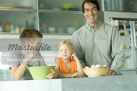 Father cooking with son and daughter