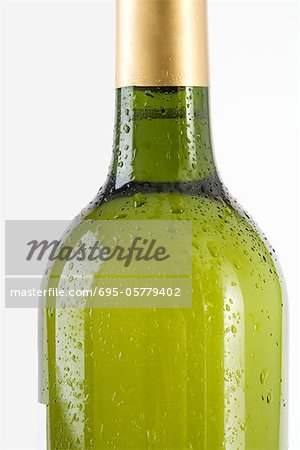 Bottle of white wine covered with drops of water, cropped