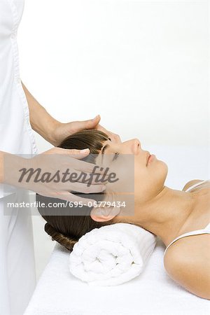 Woman receiving head massage, cropped view